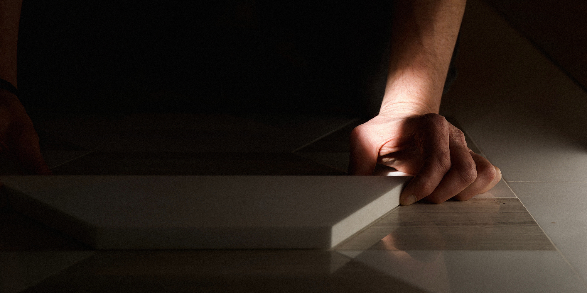 Bespoke mosaic design flooring being laid.